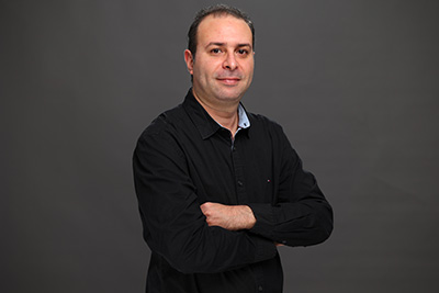 Portrait of Ali (Aly) Zouaoui, Founder and AI Strategy Lead at Esperanto Production, a leading AI strategy consultant and digital communication expert based in Tunisia